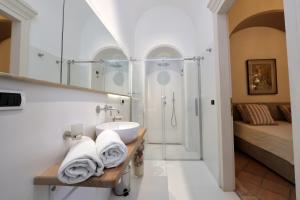 a bathroom with a sink and a shower at Casa Raiola Ercolano Luxury Rooms & Spa in Ercolano