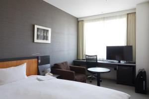 A television and/or entertainment centre at Rhino Hotel Kyoto