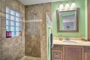 a bathroom with a shower and a sink and a mirror at Vero Beach Oasis Less Than 7 Mi to South Beach Park! in Vero Beach +19 photos