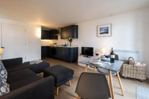 a living room with a couch and a table at Boat Lake in Thorpeness +10 photos