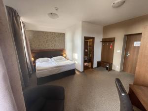 Postel nebo postele na pokoji v ubytování Hotel U Kvapilů