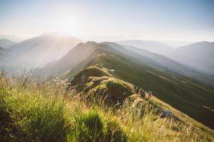 a group of people walking on top of a mountain at ALM SEASONS Premium Chalet & Studios in Saalbach-Hinterglemm