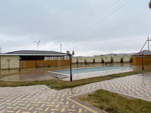 a swimming pool in front of a building at Bahri Tojik Resort & Spa in Kairakum