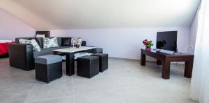 a living room with a couch and a table at Dorothea Suite in Potos +9 photos