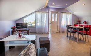 a living room with a table and a kitchen at Dorothea Suite in Potos