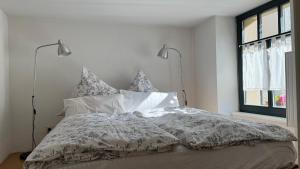 a bed with a comforter and pillows in a bedroom at Ferienwohnung im Stadionischem Hof in Walluf