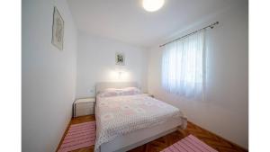 Postel nebo postele na pokoji v ubytování Apartments Magdalena
