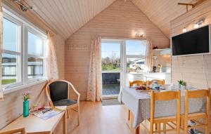 a kitchen and dining room with a table and chairs at Toftum Bjerge Camping & Cottages in Humlum +68 photos