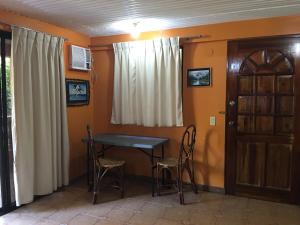 a dining room with a table and chairs and a door at Swahili Apartelle in Boracay