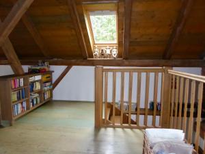 a attic room with a staircase and a window at U Devíti vidlí in Žlutice