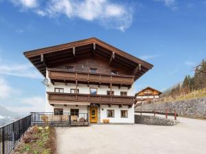 a large building with a wooden roof at Wooden apartment in Hart with terrace in Großhartberg