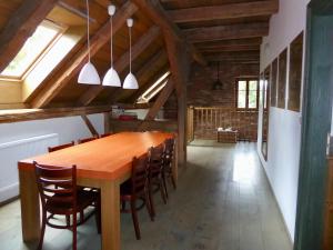 a dining room with a wooden table and chairs at U Devíti vidlí in Žlutice