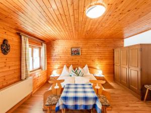 a bedroom with a bed in a wooden room at Wooden apartment in Hart with terrace in Großhartberg
