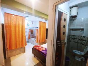a room with a bathroom with a bed and a shower at Banaras Guest House in Varanasi