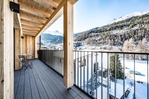 a wooden balcony with a view of the mountains at Sonnalp Residences in Sölden