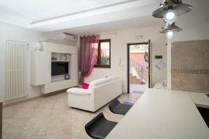 sala de estar con sofá blanco y silla en La Casetta di Chiara B&B, en Polignano a Mare