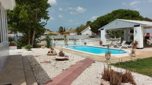 a swimming pool in the backyard of a house at El Cortijo in Chiclana de la Frontera