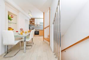 a kitchen and dining room with a table and chairs at Domino Holiday Home in Dubrovnik