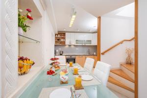 a kitchen and dining room with a table and chairs at Domino Holiday Home in Dubrovnik +22 photos