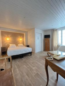 - une grande chambre avec un lit et un bureau dans l'établissement Hôtel Le Vieux Gréement, à La Couarde-sur-Mer