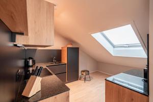 a kitchen with a skylight in the ceiling at FOREST Private Suites in Titisee-Neustadt