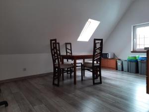 a dining room table and chairs in an empty room at Pokoje gościnne w centrum in Bogatynia