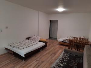 a living room with two beds and a couch at Pokoje gościnne w centrum in Bogatynia +3 photos
