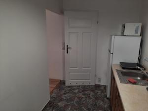 a kitchen with a white refrigerator and a sink at Noclegi w centrum in Bogatynia