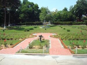 a garden with a statue in the middle of it at Hotel Triumf in Bucharest