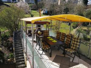 a table and chairs under an umbrella on a patio at Pension Pauly in Boppard