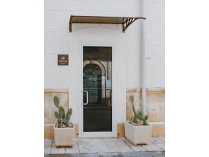 a door to a building with cactuses in front of it at Le coccole luxury Suite in Sannicandro di Bari