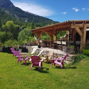 a group of chairs sitting in the grass in a yard at Camping Calme et Nature in Castellane