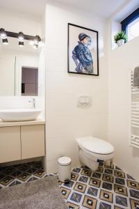 a bathroom with a toilet and a sink at V10 B Apartment in Pécs