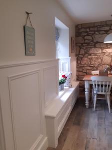 a dining room with a bench and a table at Herds House Belcoo in Belcoo