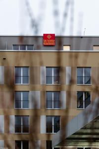 a building with a red sign on top of it at NEW OPENING 2022 - Los Lorentes Apartments Bern City in Bern