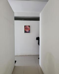 a hallway with white walls and a picture on the wall at Mega Hostel in Mirissa