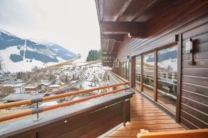 a balcony with a view of a snow covered mountain at Appartement Spielberg in Saalbach Hinterglemm