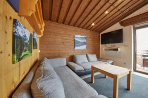 a living room with a couch and a table at Appartement Spielberg in Saalbach Hinterglemm