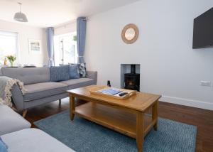 a living room with a couch and a coffee table at 38 Venn Park in Stoke Fleming