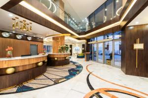 a lobby of a hotel with a reception desk at Warwick Riyadh Al Wezarat in Riyadh