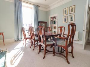 a dining room with a wooden table and chairs at Windyridge in Settle