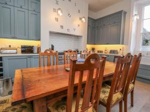 a kitchen with a wooden table and chairs at Windyridge in Settle
