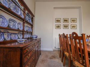 a dining room with blue and white dishes on the wall at Windyridge in Settle