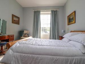 a bedroom with two beds and a window at Windyridge in Settle