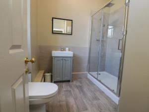 a bathroom with a toilet and a shower at Windyridge in Settle