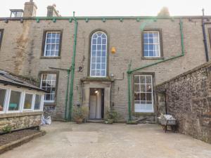 a large brick building with a door and windows at Windyridge in Settle