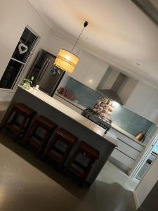 a kitchen with a stove and a counter top at Beautiful large home available in tropical north Queensland in Port Douglas