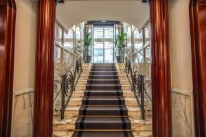 a staircase leading up to a building at The Britannia Hotel in Rome