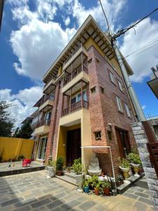 a brick building with potted plants in front of it at Munus Travel Home in Kathmandu