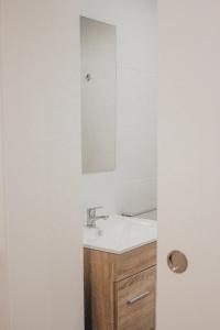 y baño con lavabo y espejo. en Vivienda de Uso Turístico MARINA LUXURY en Padrón